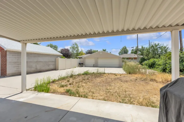 Expansive concrete patio with a covered pergola