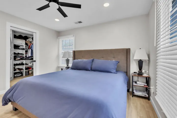 Bedroom featuring wood-finish flooring, recessed lighting, and a black ceiling fan