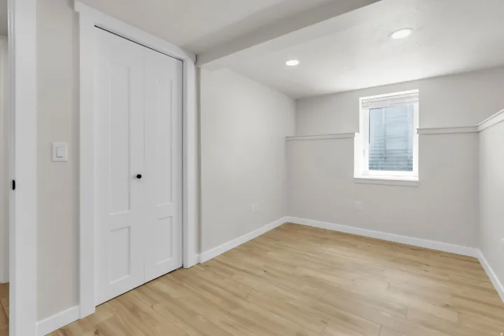 Light wood-finish flooring complements the neutral wall tones