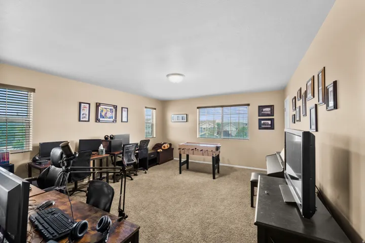 Spacious room with neutral wall tones and carpet flooring