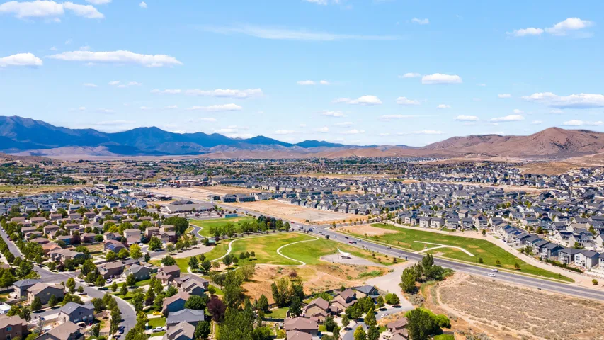 Expansive aerial view showcasing a large residential community with numerous homes