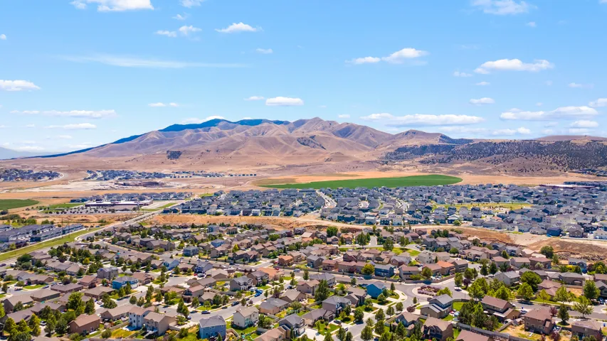 Expansive residential development featuring varied housing styles, mature landscaping, and paved streets