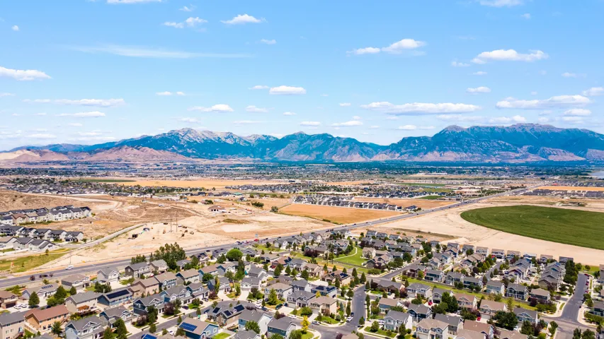 Expansive residential area featuring numerous single-family homes, wide paved streets, and green spaces