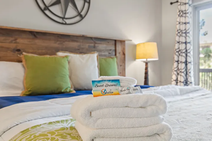 Wood-panel headboard framing a bed with decorative bedding