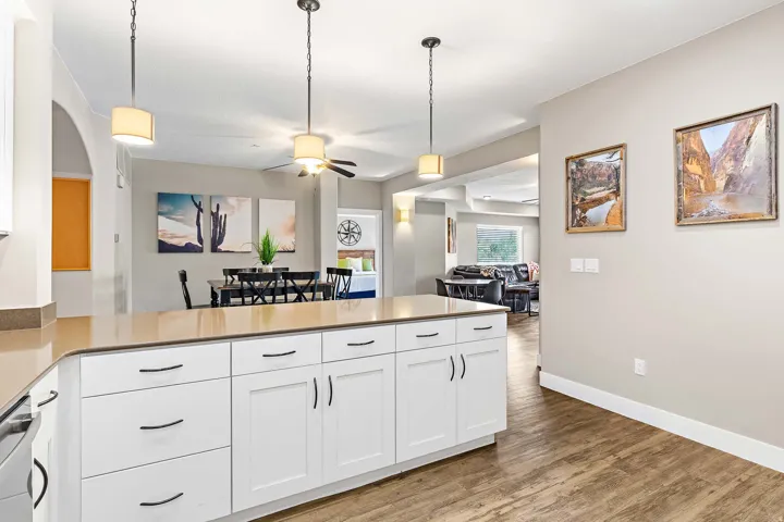 Spacious kitchen island with white shaker cabinetry, black hardware, and an expansive countertop