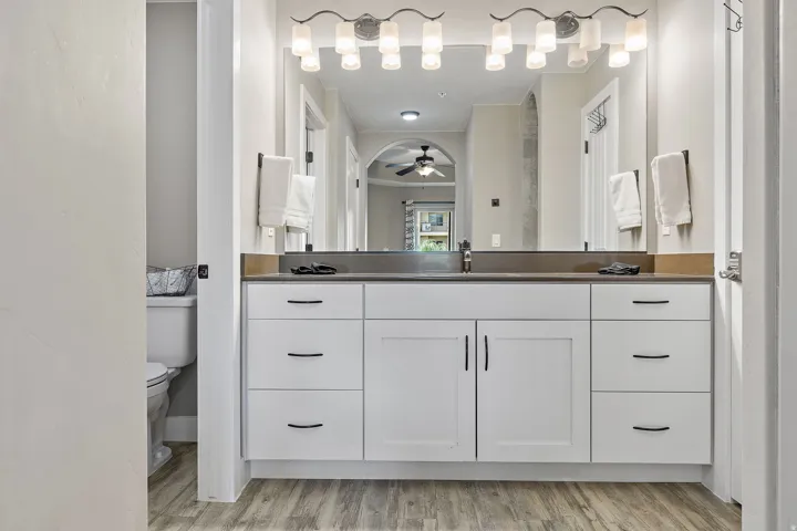 Dual vanity with white cabinetry and dark hardware