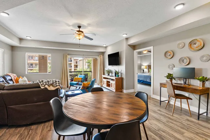 Open-concept living area featuring wood-finish flooring, recessed lighting, and a ceiling fan