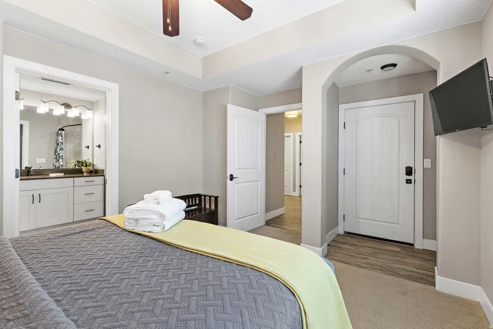 Bedroom featuring a tray ceiling, recessed lighting, and a ceiling fan with wood-finish blades