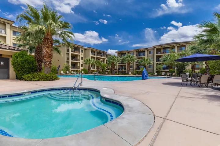 Poolside amenities featuring a spa, two swimming pools, and surrounding patio space
