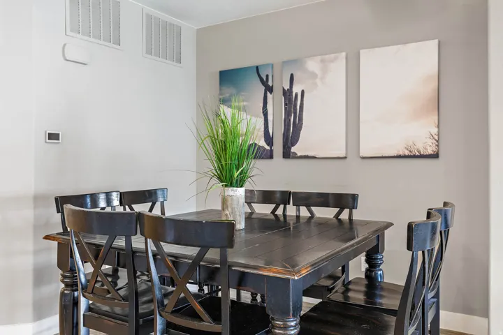 Dining area featuring neutral wall tones and a dark wood table with matching chairs