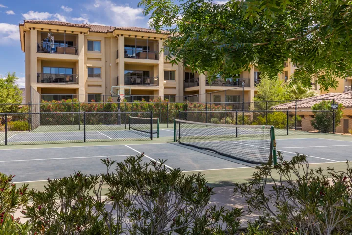 Multi-sport court featuring a tennis net and basketball hoop