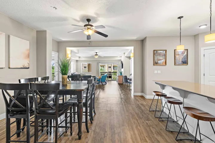 Open-concept living area with wood-finish flooring, recessed lighting, and ceiling fans