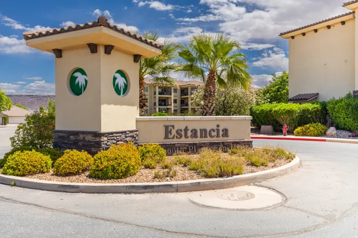 Property entrance signage featuring a stacked stone base and stucco finish