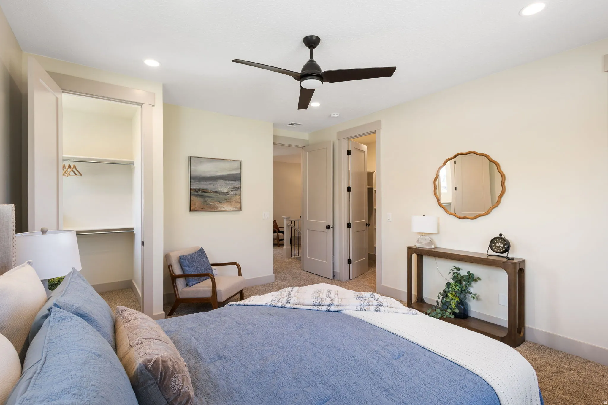 Bedroom featuring light-toned walls, recessed lighting, and a dark-toned ceiling fan