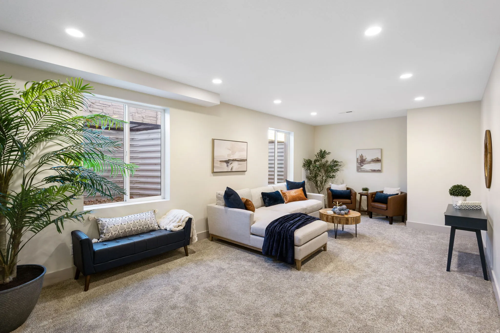 Expansive carpeted room featuring recessed lighting and two egress windows
