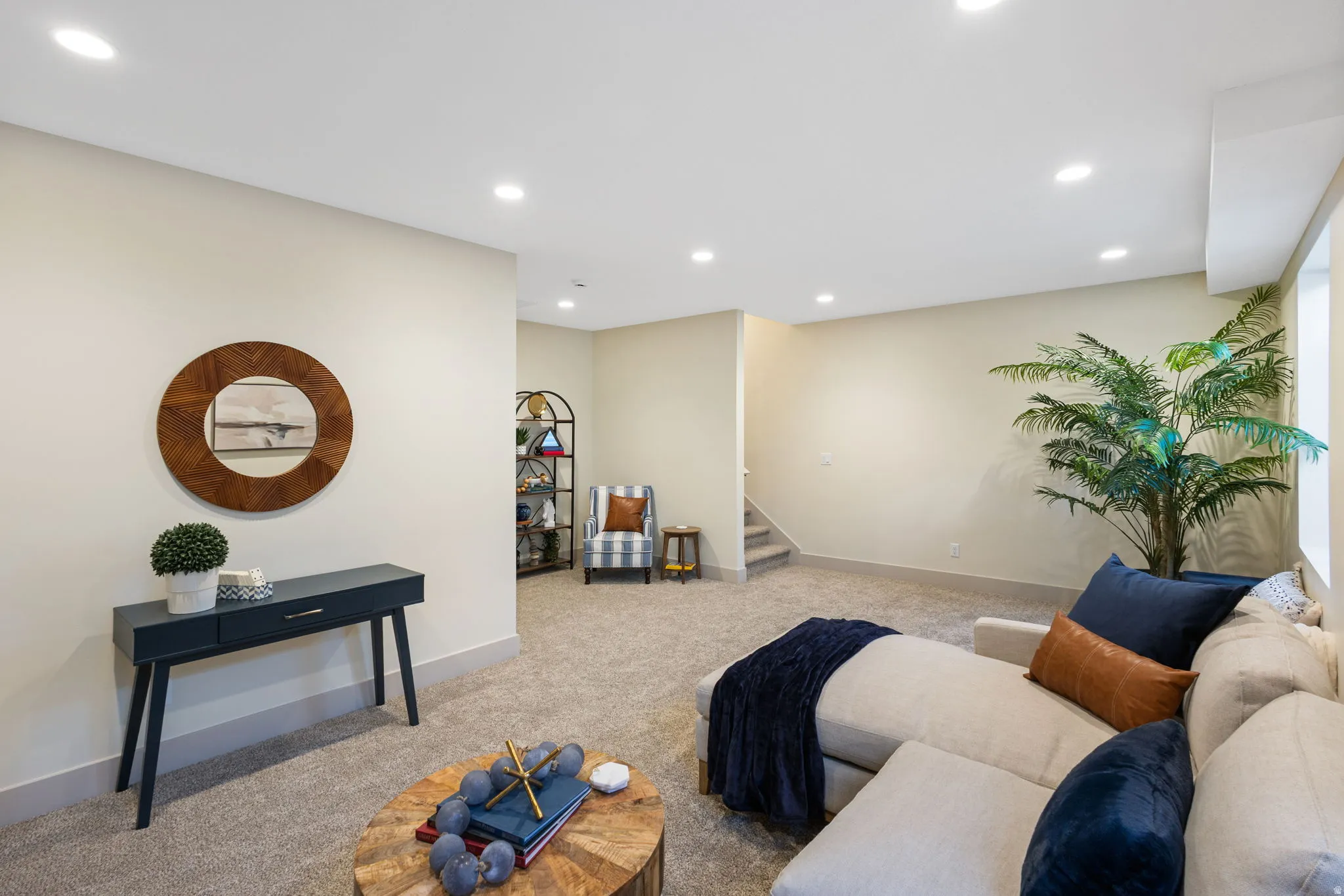 Spacious room featuring neutral carpeting, recessed ceiling lighting, light-toned wall paint, and white trim