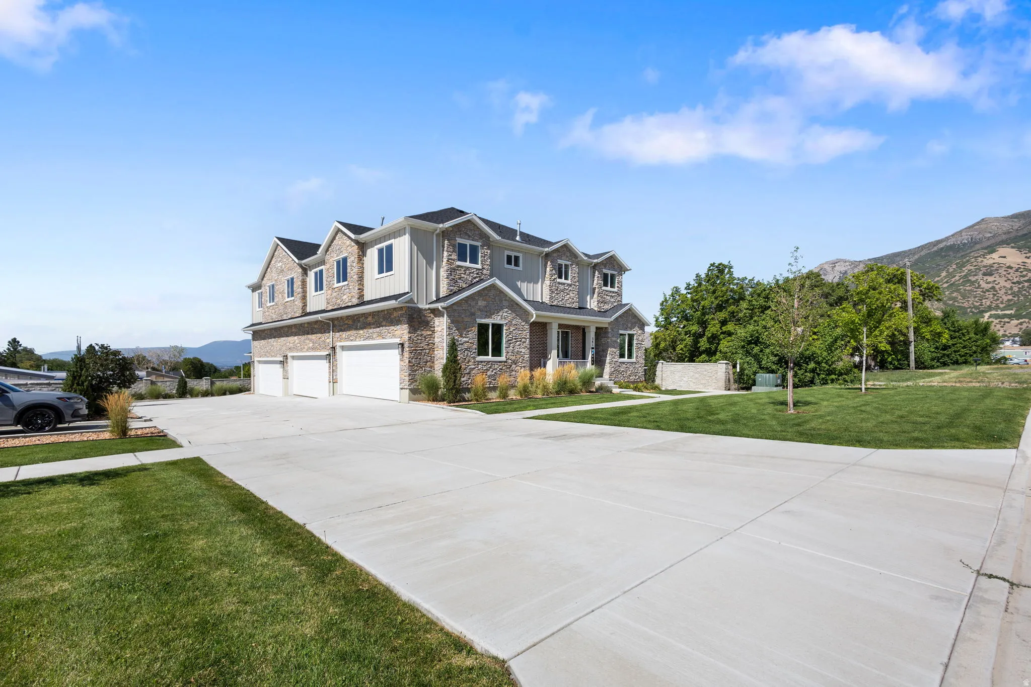 Stone and siding exterior with prominent three-car garage