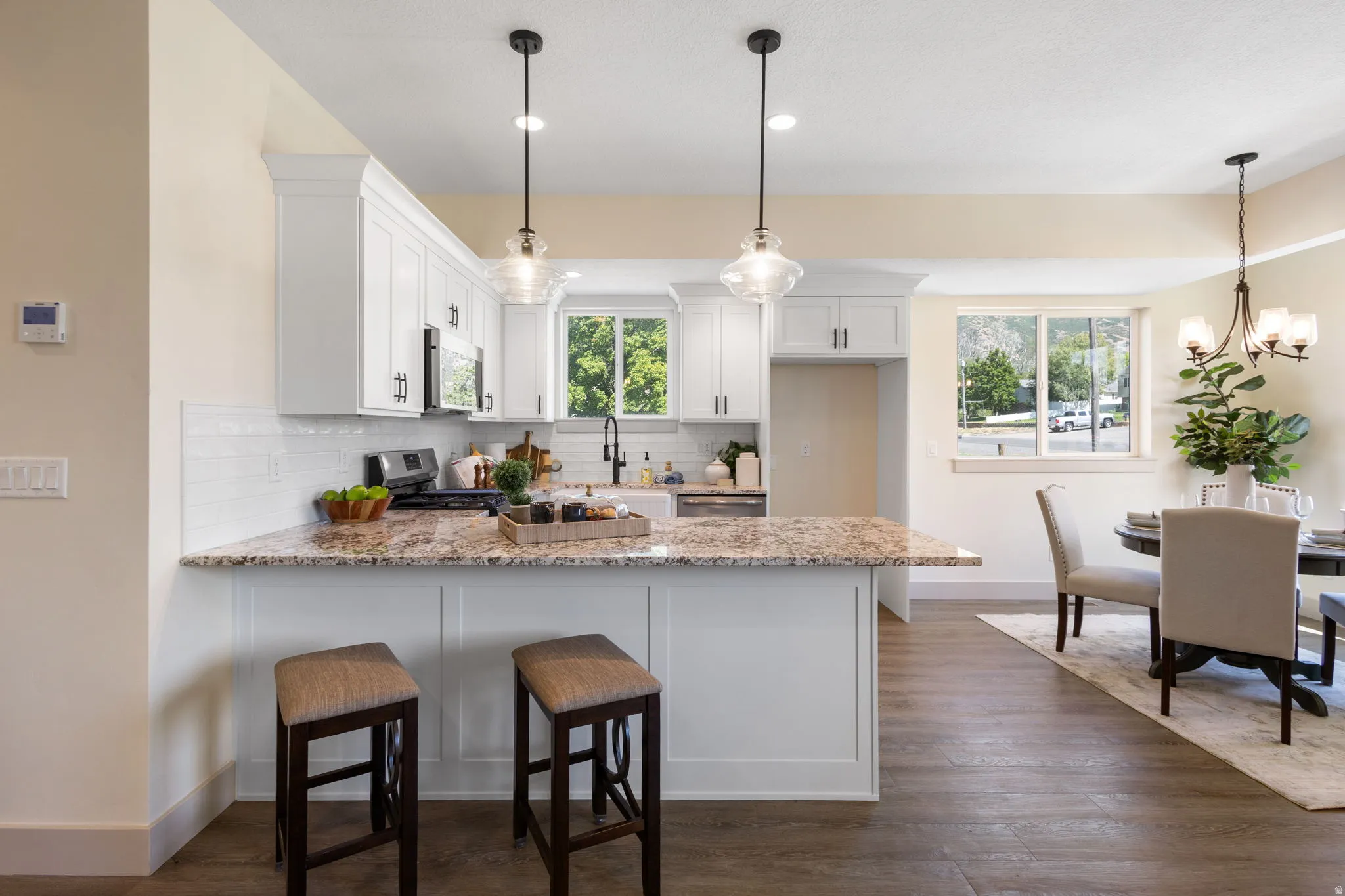 Kitchen featuring white shaker cabinetry and granite countertops