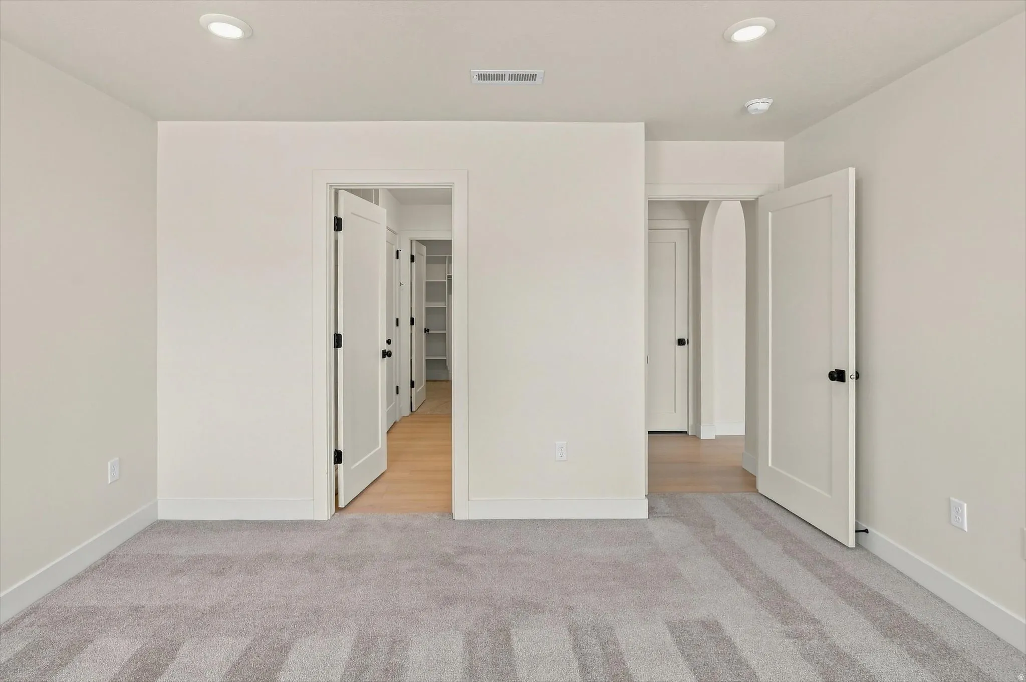 Neutral interior room featuring recessed lighting and light gray carpeting