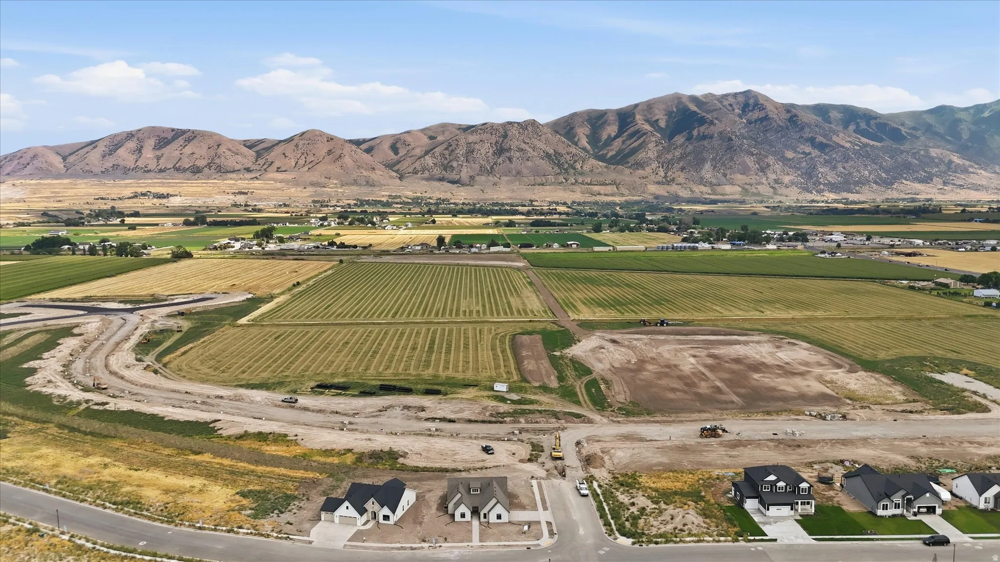 Newly constructed residential properties with concrete driveways and manicured lawns