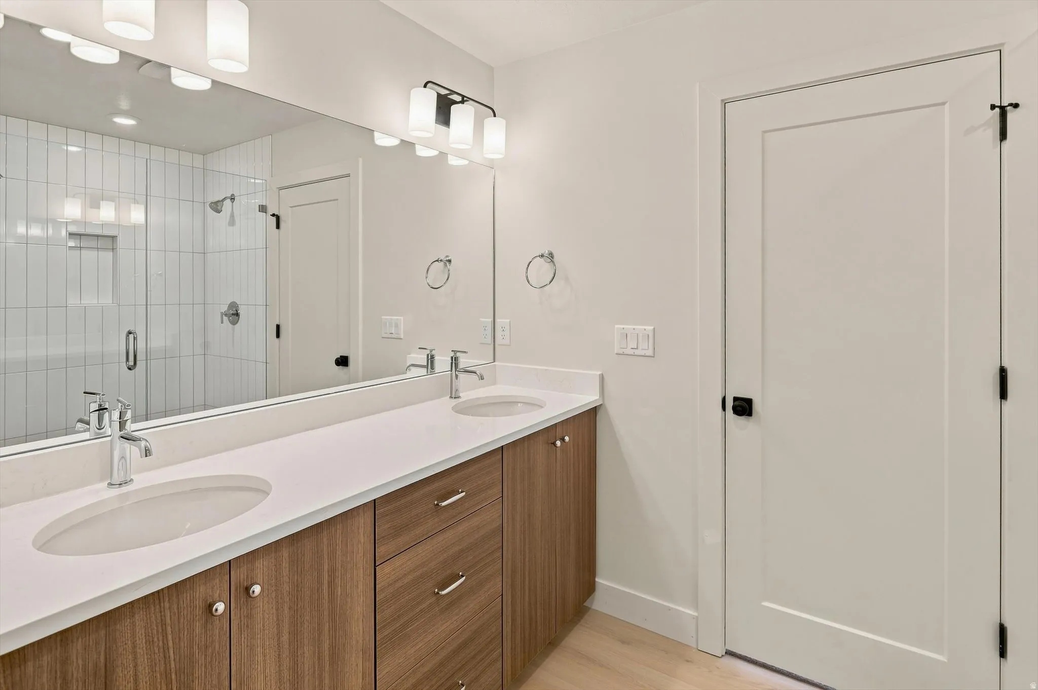 Double vanity featuring a light-toned countertop, two integrated sinks, and chrome faucets