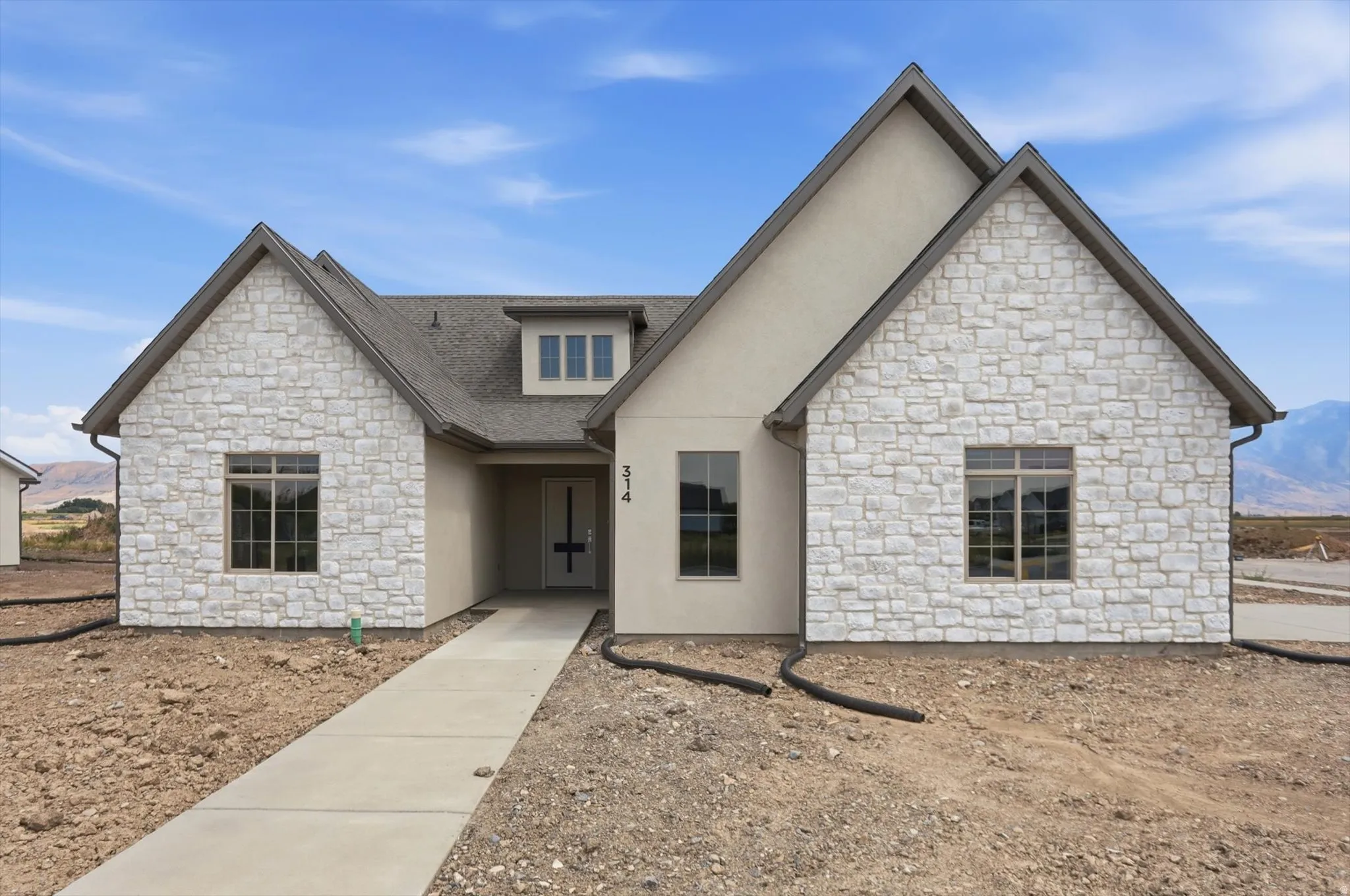 Contemporary home featuring a stone facade and stucco accents