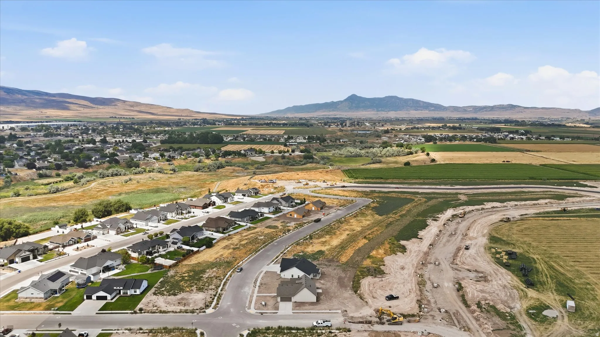 Aerial perspective showcasing an established residential development alongside new construction sites