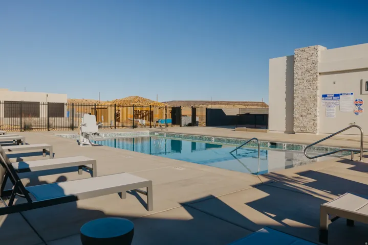 Outdoor swimming pool with integrated access lift and stainless steel handrails