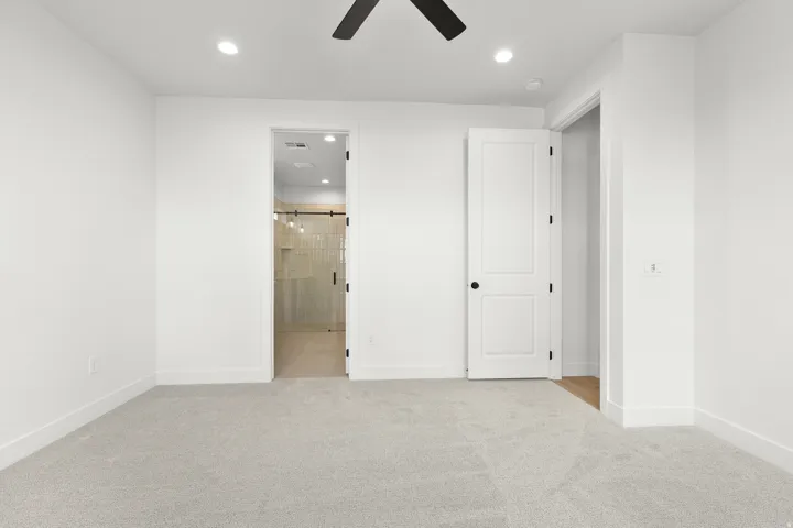 Carpeted room featuring white walls, recessed lighting, and a ceiling fan