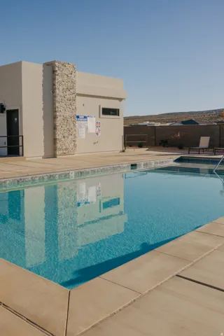 Rectangular outdoor swimming pool featuring a light blue finish, complemented by a surrounding concrete deck