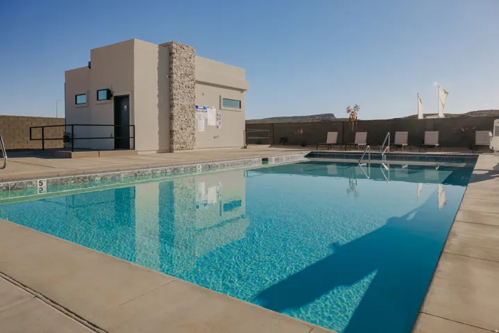 Outdoor swimming pool with integrated steps, surrounded by a concrete deck