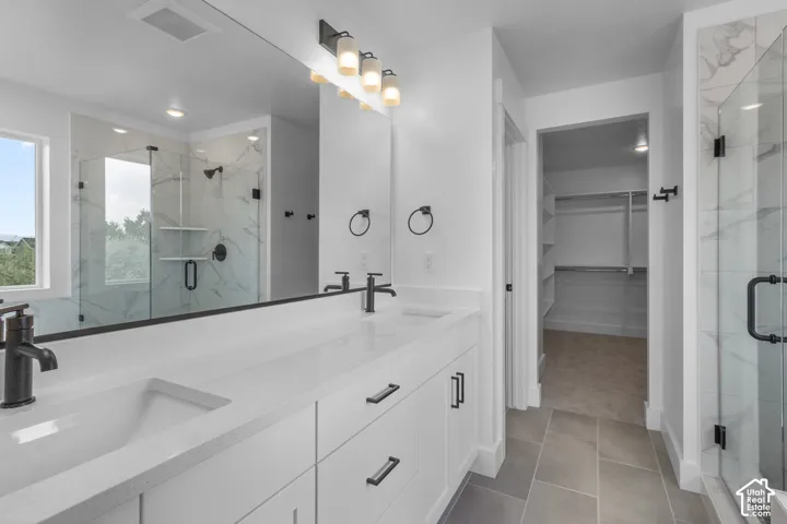 Dual sink vanity with white countertops and matte black fixtures