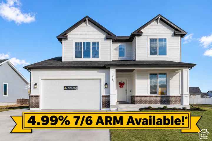 Two-story residence with a covered entry, attached two-car garage, and a combination of horizontal siding and brick veneer
