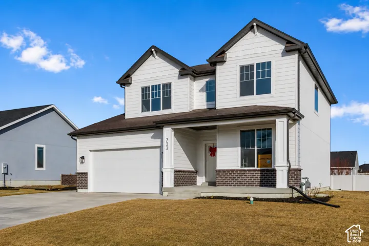 Two-story residence featuring white siding and dark shingle roofing