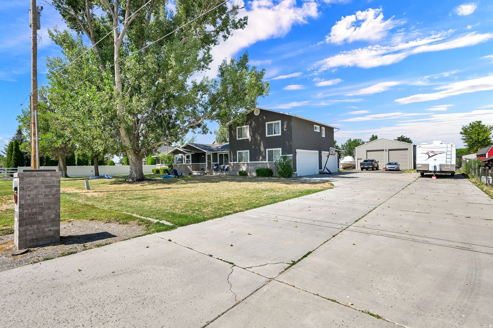 Concrete driveway leading to a two-story residence with an attached two-car garage