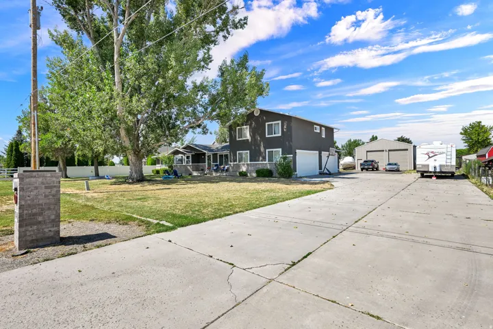 Concrete driveway leading to a two-story residence with an attached two-car garage