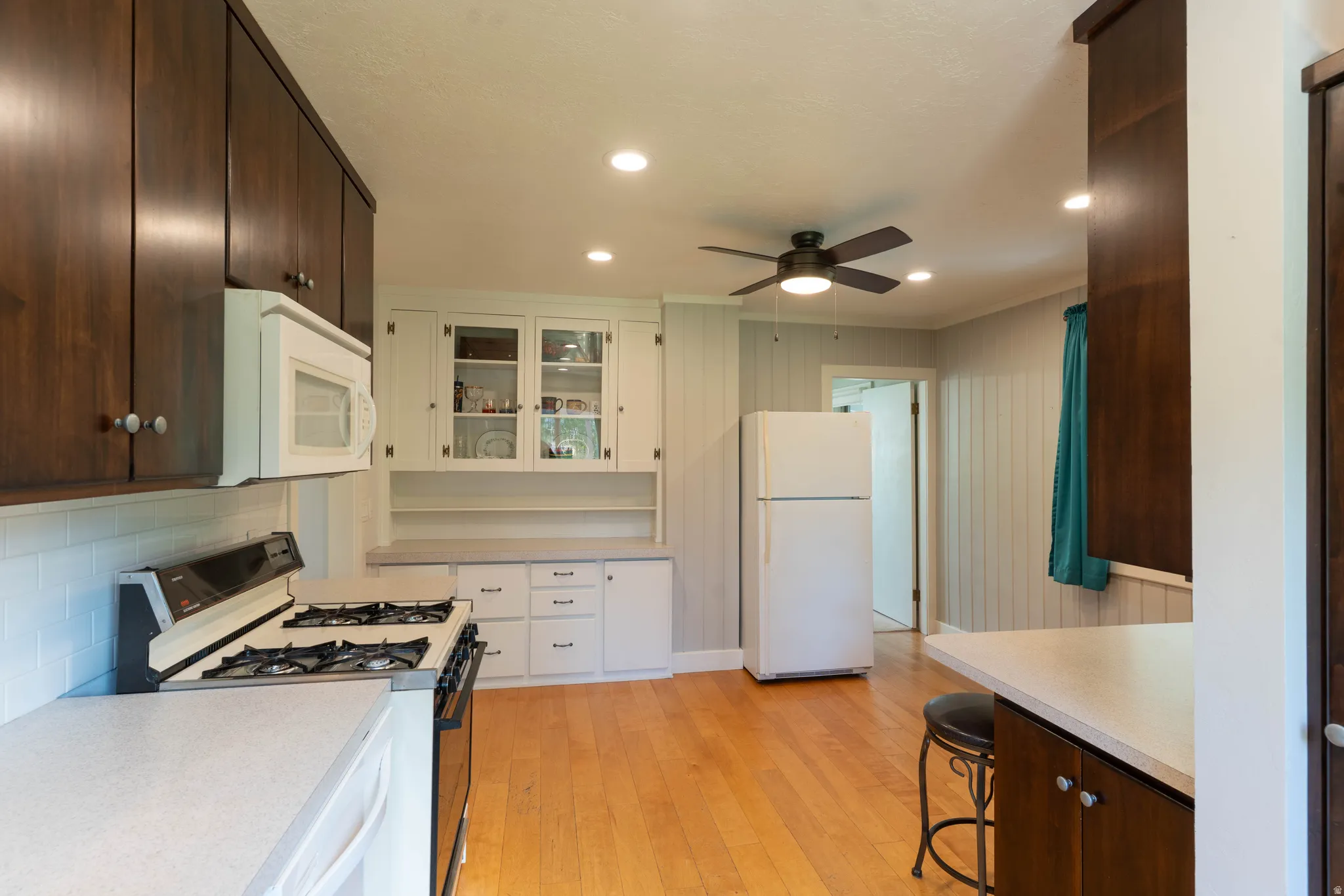 Kitchen featuring warm wood-finish flooring, recessed lighting, and a ceiling fan
