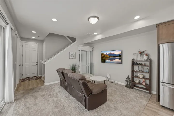 Open-concept living area with light gray walls and recessed lighting