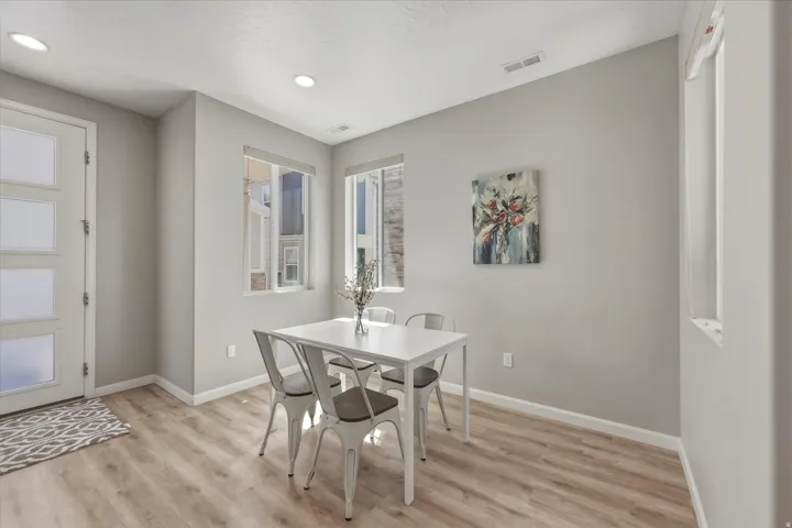 Bright interior space with wood-finish flooring, recessed lighting, and multiple windows