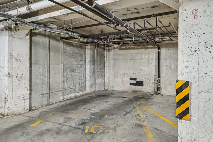 Dedicated parking space with concrete walls and ceiling