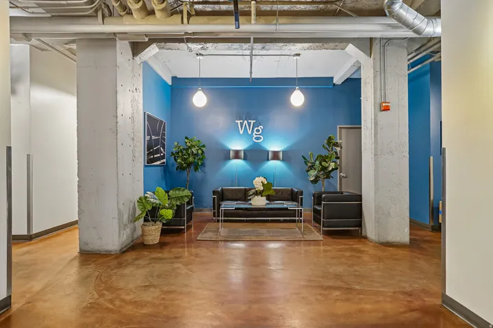 Lobby area featuring concrete structural columns and stained concrete flooring