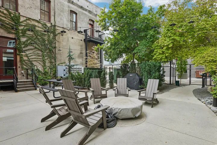 Expansive concrete patio with a circular fire pit