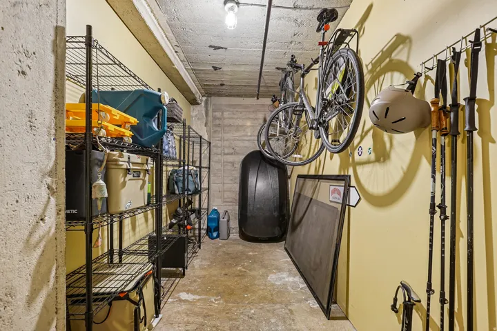 Spacious storage area featuring concrete flooring and exposed concrete ceiling