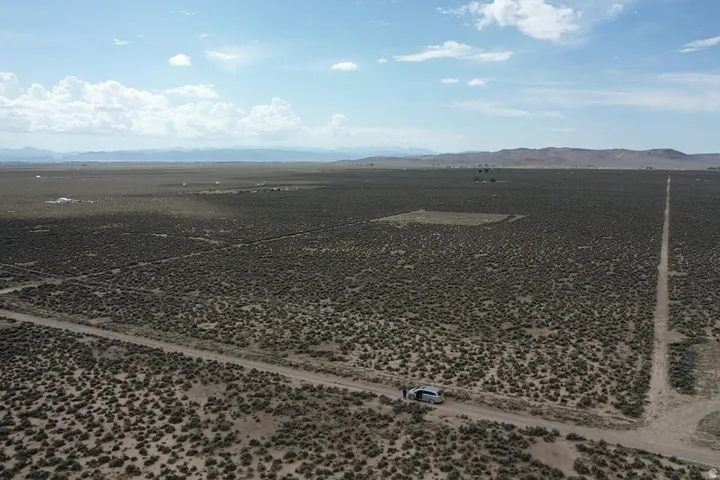Expansive desert landscape featuring natural scrub vegetation