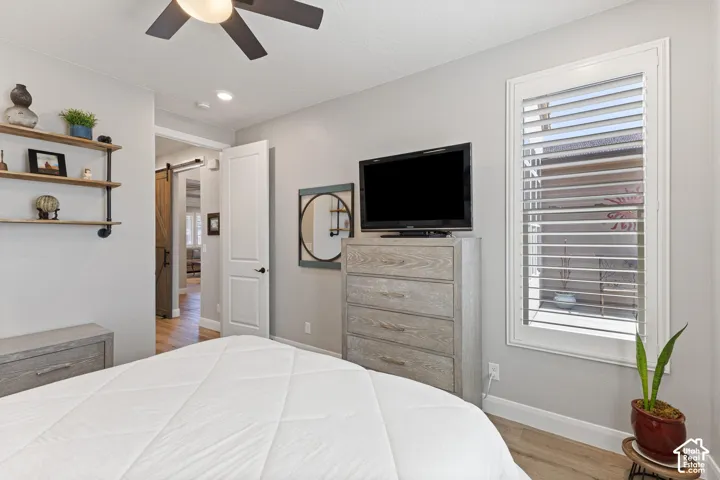 Room featuring wood-finish flooring and a ceiling fan