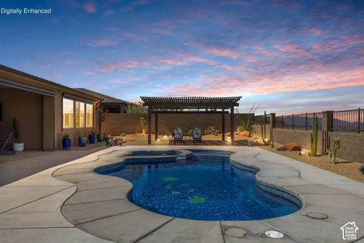 Freeform swimming pool with integrated spa and concrete decking