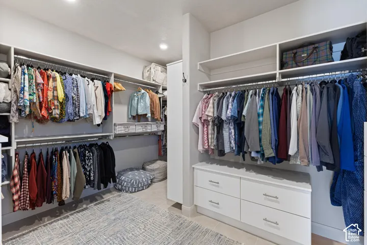 Custom closet system featuring hanging rods, shelving, and built-in drawer storage