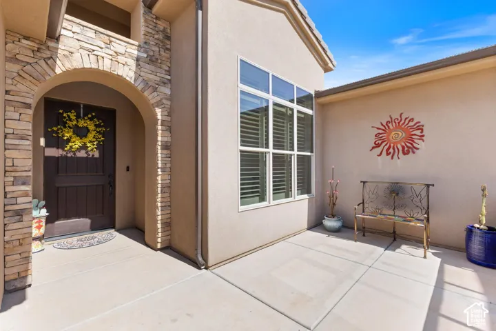 Stucco exterior with stone archway entry