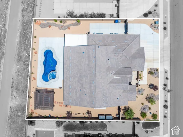 Aerial perspective showcasing a single-story residence with a multi-gabled roof and an integrated swimming pool