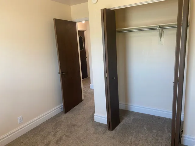 Cream-colored walls paired with brown bi-fold closet doors and wood-finish interior doors